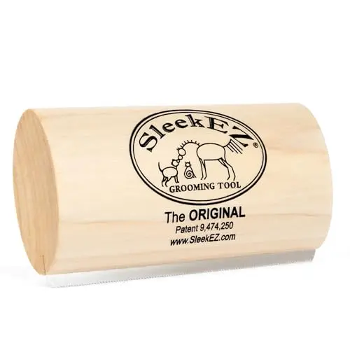 SleekEZ dog brush with wooden handle and stainless steel bristles on a furry background